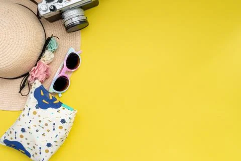 Composition with beach accessories and space for text on yellow background. Stock Photos