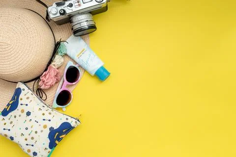 Composition with beach accessories and space for text on yellow background. Stock Photos