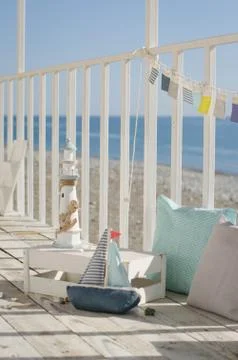 Composition with beach decoration shells, toy boat and lighthouse, with pillo Stock Photos