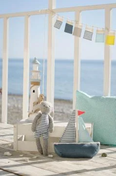 Composition with beach decoration shells, toy boat, toy bunny and lighthouse, Stock Photos