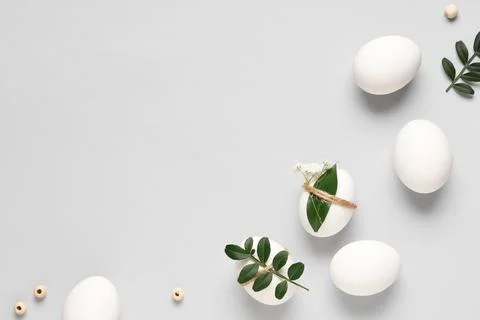 Composition with beautiful Easter eggs and green twigs isolated on white back Stock Photos