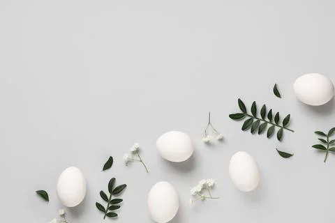 Composition with beautiful Easter eggs, gypsophila flowers and green twigs is Stock Photos