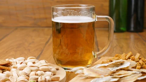 The composition of beer, crackers, pistachios, dried fish (No 3.3, Dolly) Stock Footage 67299373