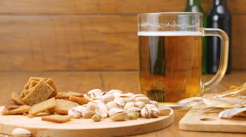 The composition of beer, crackers, pistachios, dried fish (No 3.2, RL Pan) Stock Footage 67299860