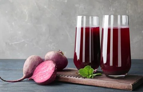 Composition with beet juice on table against grey background Foto stock