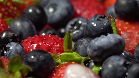 Composition of berries on a rotating table,strawberries and blueberries Stock Footage 158580398