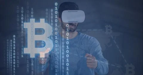 Composition of binary coding bitcoin symbols over man wearing vr headset 스톡 사진