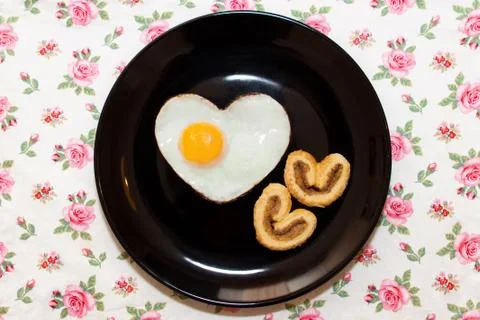 Composition of biscuits and egg in heart shape. Valentine's Day Stock Photos