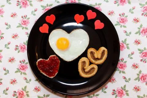 Composition of the biscuits, sandwich with jam, and scrambled egg in heart .. Stock Photos