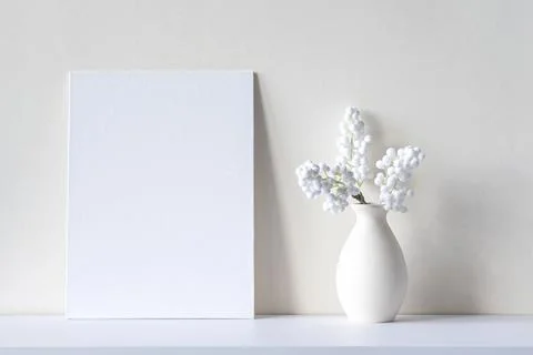 Composition with blank canvas or sheet, vase, decorative house plant Stock Photos