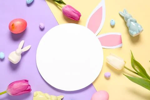 Composition with blank card, decorative rabbits, tulip flowers and Easter egg Stock Photos