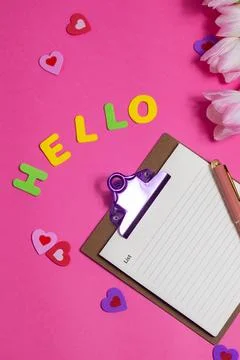 Composition with blank, word Hello and beautiful tulip flowers on pink back.. Stock Photos