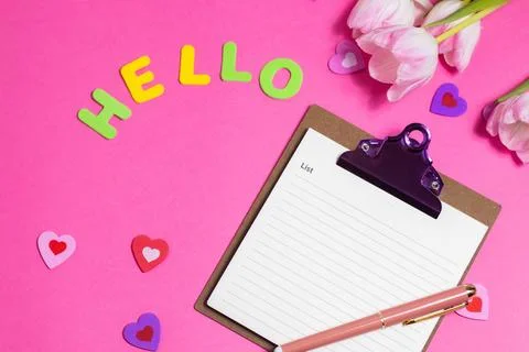 Composition with blank, word Hello and beautiful tulip flowers on pink back.. Stock Photos