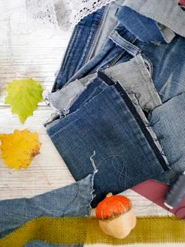 Composition of blue fabric of jeans, threads, autumn leaves, pumpkins Stock Photos
