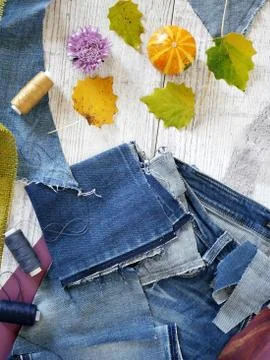 Composition of blue fabric of jeans, threads, autumn leaves, pumpkins Stock Photos