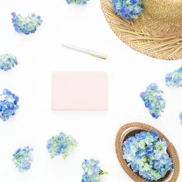 Composition of blue flowers with straw, diary on white background. Flat lay,  Stock Photos