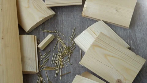 Composition of boards, nails and hammer,the hand takes the hammer out of the Stock Footage 76632370