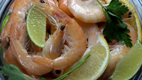 Composition of boiled shrimps, lemon and lime slices Stock Footage 165077016