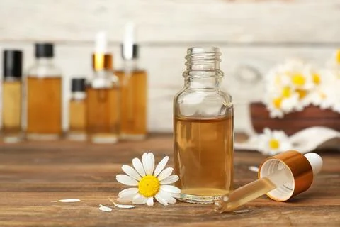 Composition with bottle of chamomile essential oil on table. Space for text Foto stock