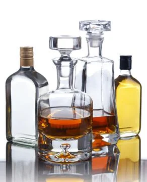 Composition with bottles of assorted alcoholic beverages. Stock Photos