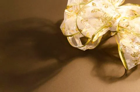 Composition with a bow on a brown background Stock Photos