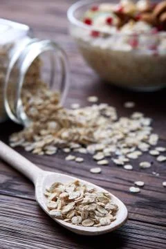 Composition with bowl of oatmeal porrige and dry oatmeal in glassware on vintage Stock Photos