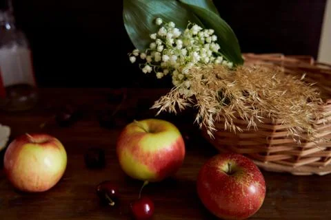 Composition Braided basket with red apples on a black background Stock Photos