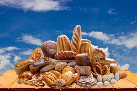 Composition with bread and rolls  against the blue sky Stock Photos