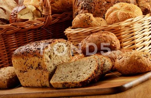 Composition with bread and rolls in wicker basket Stock Photos