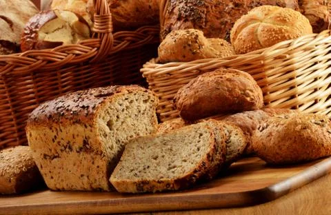 Composition with bread and rolls in wicker basket Stock Photos