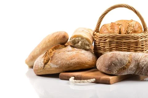 Composition with bread and rolls in wicker basket isolated on white Stock Photos