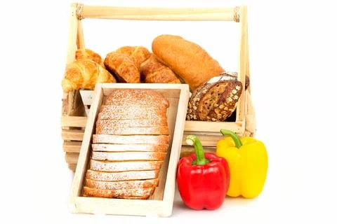 Composition with bread and vegetable in basket isolated on white Stock Photos