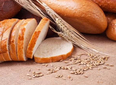 Composition of bread and wheat spikelets Stock Photos