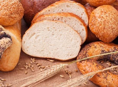 Composition of bread and wheat spikelets Stock Photos