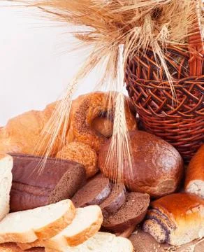 Composition of bread and wheat spikelets Stock Photos