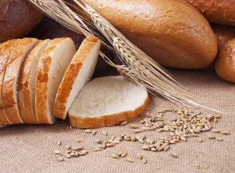 Composition of bread and wheat spikelets Stock Photos