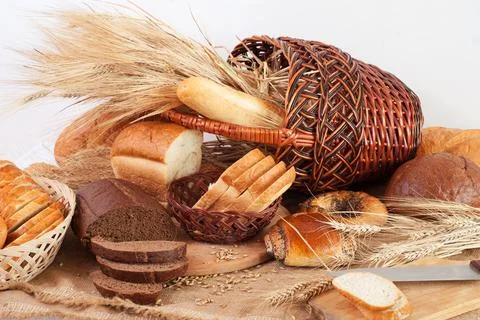 Composition of bread and wheat spikelets Stock Photos