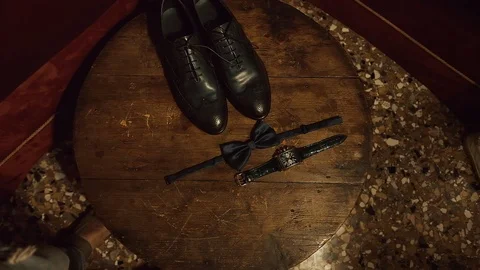 Composition Of The Bridegroom Accessories On A Brown Background. Video stock 106090964