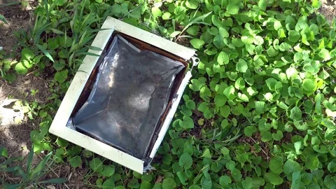 Composition of a broken computer on the grass Stock Footage 75445208