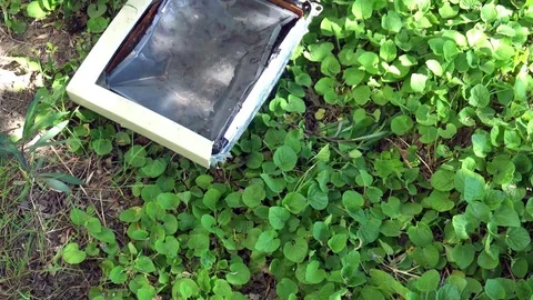Composition of a broken computer on the grass Stock Footage 75445285