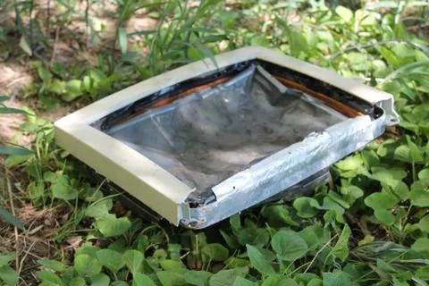 Composition of a broken computer on the grass Foto stock