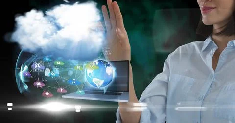 Composition of businesswoman using interactive screen with laptop, cloud and Stock Photos