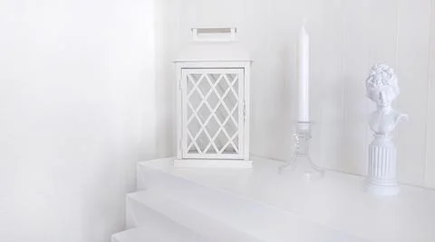 Composition with a candlestick a lantern and a statuette Stock Photos