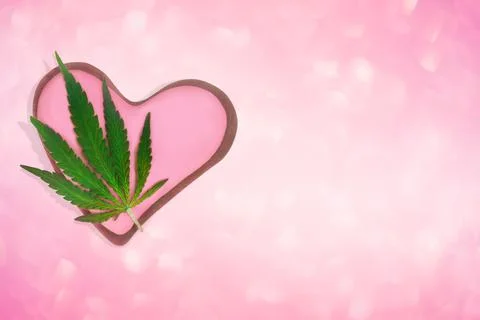 Composition with cannabis leaf and decorated cookies and heart-shaped space 写真素材
