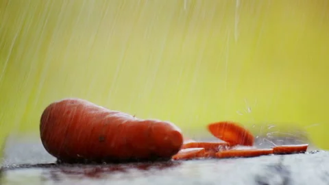 Composition with carrots on the table in the rain. Video stock 114430559