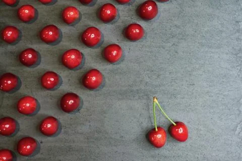 Composition of cherries on a black stone background Foto stock