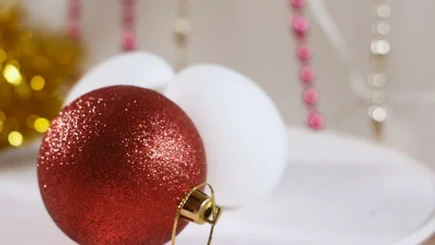 The composition of a Christmas ball and two white eggs Stock Footage 221120891