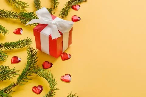 Composition with Christmas tree branches, red gift box and glass hearts on a Stock Photos