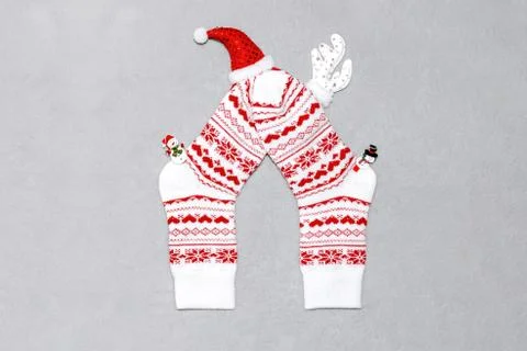 Composition of Christmas white wool socks, deer horns, hat and snowmen on a g Stock Photos