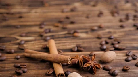 Composition of the cinnamon sticks and beans of coffee on a wooden table. Stock Footage 131004820